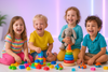 Realistic photo of happy kids playing together and enjoying with their colorful toys in a bright, modern play area. The background has a soft white and light purple neon glow theme, giving a cheerful and clean aesthetic. The kids are smiling, active, and full of joy, surrounded by toys like building blocks, plush animals, and cars. The lighting is soft and dreamy, creating a playful and positive vibe